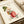 Cozy cottagecore watercolor illustration of a character on a scooter with botanical details and a dragonfly, displayed as a framed poster in cream, red, and muted green tones.