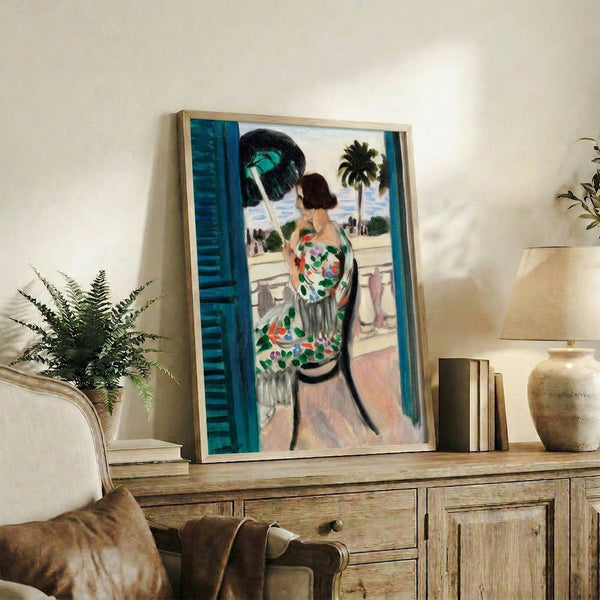 Elegant framed poster of a woman perched on a balcony, rendered in washed-out pastels with contemplative, understated composition.