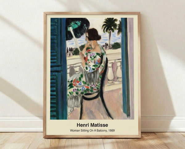 Abstract framed poster of a contemplative woman seated on a balcony, rendered in bold ochre, blue, and green tones with minimalist forms.