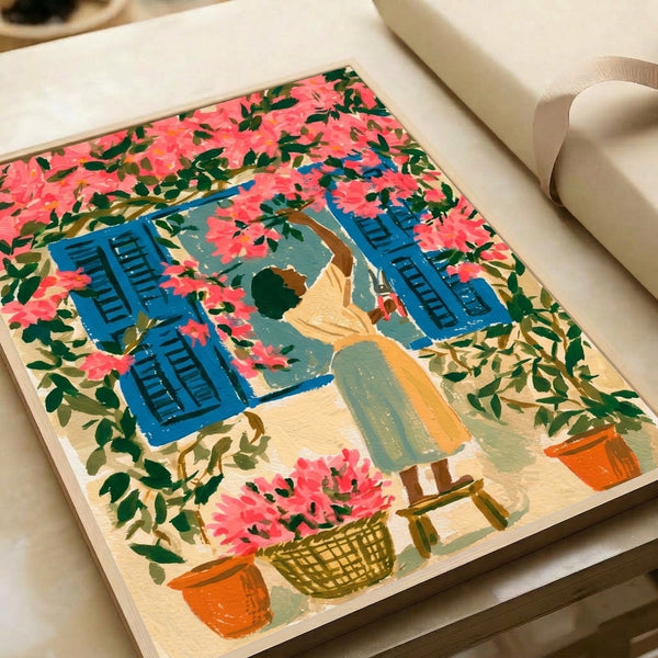 Vintage-style framed poster depicting a serene Mediterranean scene with a woman pruning lush bougainvillea blooms in shades of coral and pink beside a cream-colored window.