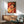 Contemporary wall poster of a seated woman with guitar rendered in simplified forms and a harmonious palette of ochre, blue, and neutral hues.
