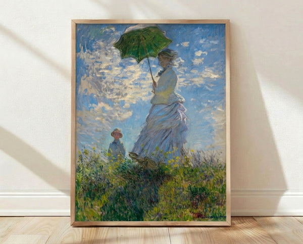 Impressionist painting of a woman holding a parasol standing in a sunlit field with a child, rendered in soft blues, yellows, and greens on a framed poster.