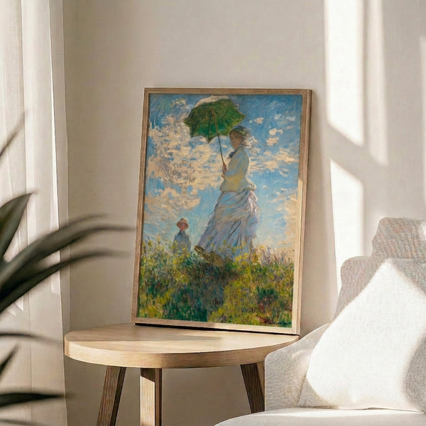 Framed impressionist masterpiece portraying an elegant woman with parasol escorting a child through a sunlit natural landscape with soft, blended hues.