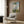 Impressionist wall print capturing a peaceful moment of a parasol-carrying woman and child in a sun-flooded meadow with gauzy, luminous brushstrokes.