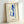 Minimalist art print showing a poised woman with classical amphora in ochre, crimson, and cream, exemplifying restrained modern aesthetic.