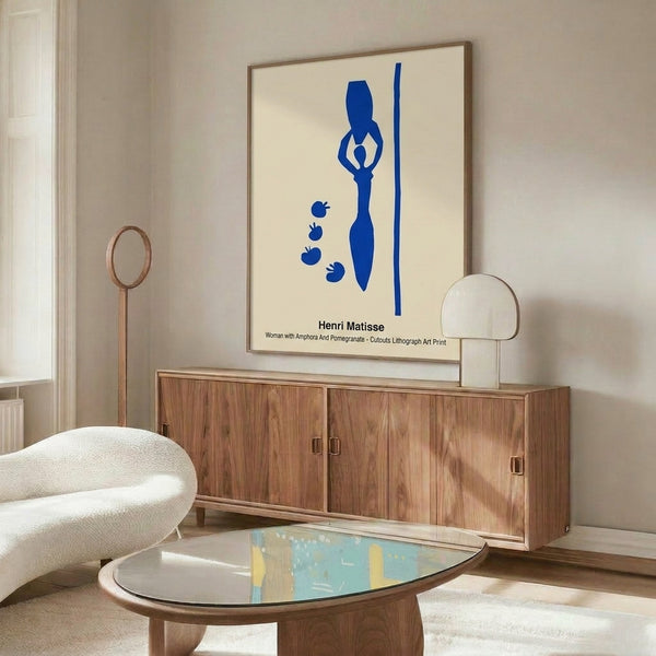 Abstract art print featuring a refined female silhouette, classical amphora, and pomegranate in cream, ochre, and crimson on a framed wall display.