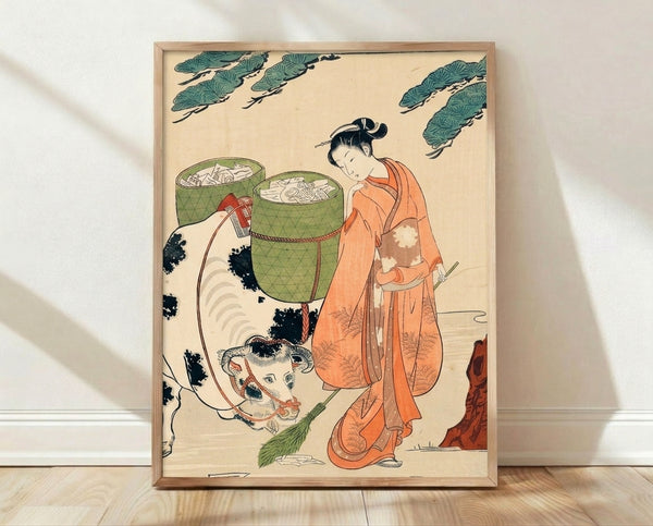 Framed Japanese woodblock print depicting a serene woman in a patterned kimono standing beside a cow, with bamboo baskets and sage green tones in a folkloric domestic scene.