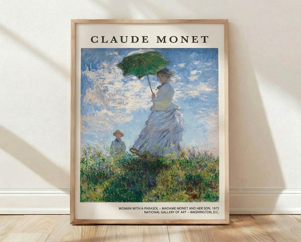 Impressionist painting of a woman in a white dress holding a parasol in a sunlit flower field, with a child beside her and soft blue sky above, framed poster print on wall.