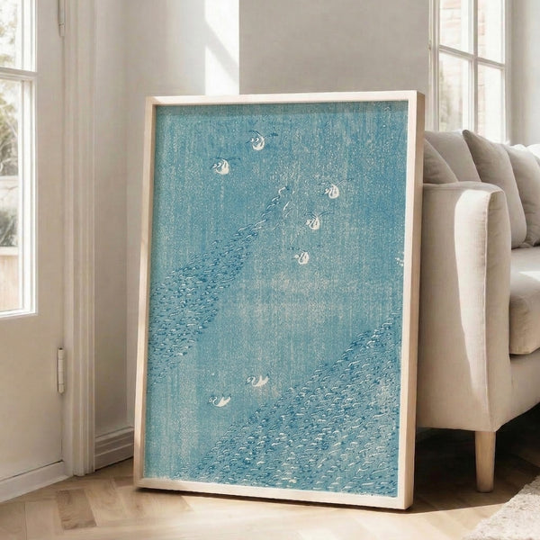 Vintage-style Japanese woodblock print capturing windswept birds and water plants amid stormy conditions, rendered in atmospheric blues and creams.