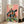 Vintage-style woodblock inspired poster of a woman in ornate kimono surrounded by magical florals and sparkles, blending folk art traditions with whimsical Art Nouveau design in warm and cool tones.