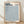 Abstract minimalist poster with repeating geometric patterns in cream and steel blue, creating a meditative hypnotic composition framed on wall.