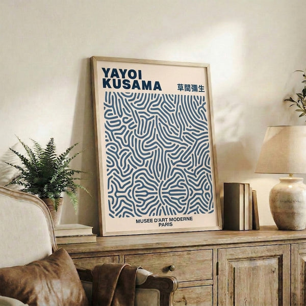Framed minimalist artwork featuring dense geometric patterns in white and steel blue on cream ground, contemporary and meditative composition.