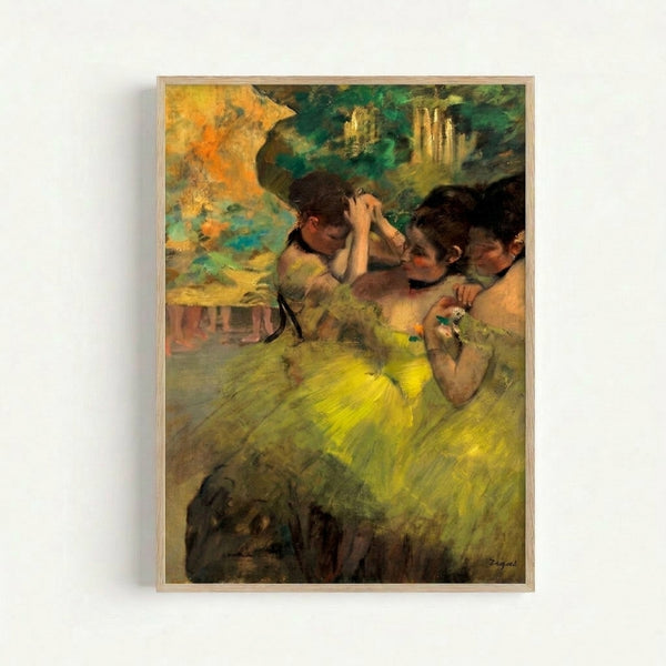 Degas-style framed art print depicting dancers in warm ochre and yellow hues with flesh tones, evoking an intimate backstage rehearsal scene in muted palette.