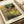 Impressionist ballet dancers poster in soft golden yellow, cream, and light blue palette, showcasing an intimate behind-the-scenes moment with graceful figures.