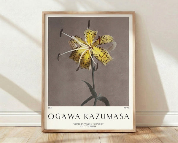 Framed Japanese woodblock print of a spotted lily with yellow petals and sage green leaves on cream background, displaying elegant botanical artwork in vintage style.
