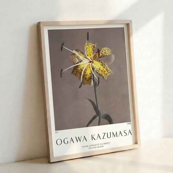 Framed poster of a refined Japanese lily illustration in pale yellow with dark brown markings and natural green foliage, executed in classic woodblock aesthetic.