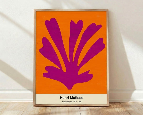 Abstract framed poster with vibrant yellow and pink cut-out shapes on white background, creating a playful minimalist composition with balanced negative space.