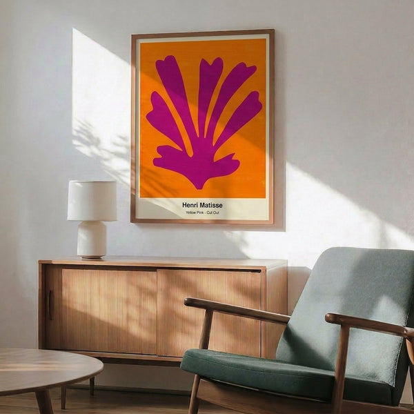 Modern minimalist poster displaying vibrant pink and yellow forms with striking negative space, expressing artistic sophistication through restrained, playful abstraction.