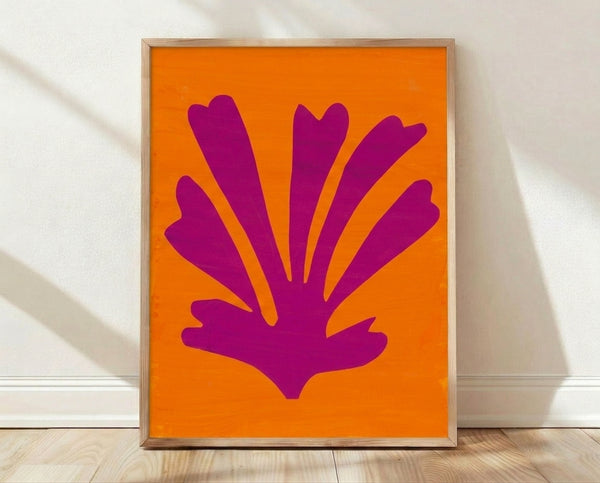 Abstract cut-out poster in warm yellow and soft pink tones, inspired by modernist paper collage art, displayed as a framed print on a wall.