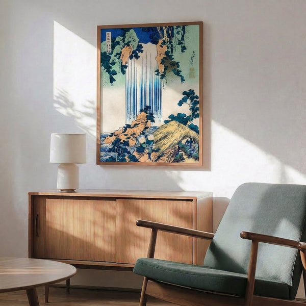 Framed Japanese landscape art print capturing the peaceful grandeur of a mountain waterfall amid towering trees and misty peaks in restful blue, ochre, and forest tones.