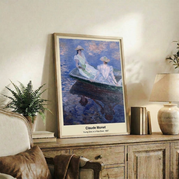 Girls in a wooden rowboat floating on calm water, painted with Impressionist softness and Japanese woodblock sensibility in cream, blue, and rose palette, framed on a wall.