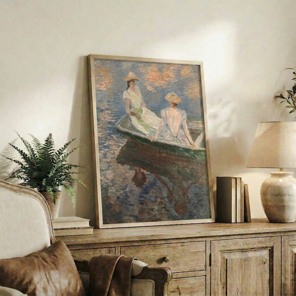Framed impressionist print featuring young girls boating, rendered in cool blue and green hues with soft, atmospheric brushwork.