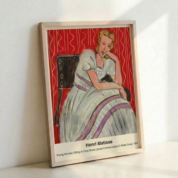 Art Nouveau influenced watercolor portrait of a young woman seated in a gray dress, her thoughtful gaze set against an ornate, colorfully patterned wall.