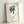 Japandi wall art displaying traditional brush stroke character in black ink on taupe-toned background, embodying wabi-sabi minimalist design.