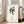 Minimalist framed poster with serene black calligraphic brushwork on cream canvas, reflecting zen philosophy and meditative tranquility.