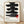 Framed minimalist poster featuring bold black Japanese kanji brushstrokes stacked vertically with a red accent, cream background, evoking calm and meditative wabi sabi aesthetics.