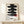 Framed Japanese brushstroke artwork in black and red tones on cream, featuring contemplative kanji characters in a calming, wabi sabi minimalist style.
