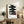Contemplative wall print with gestural black kanji brushstrokes and red detail on cream background, capturing serene Japandi and Zen aesthetic sensibilities.