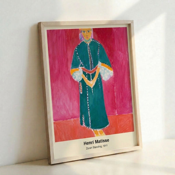 Modern art print on wall showing a stylized standing woman in terracotta and ochre hues with bold blue accents, capturing contemplative beauty in Matisse's expressive manner.