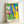 Framed decorative poster displaying abstract shapes in rich primary color fields with a dynamic, playful aesthetic characteristic of modernist cut-out art.